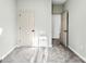Neutral bedroom features plush carpeting, a nearby closet, and an open doorway at 7108 Founders Club Ct, Charlotte, NC 28269