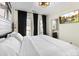 Well-lit bedroom featuring large windows, soft bedding, and access to en-suite bathroom at 7108 Founders Club Ct, Charlotte, NC 28269