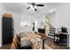 Elegant dining area featuring a ceiling fan, a black table with seating for six, and staircase access at 7108 Founders Club Ct, Charlotte, NC 28269