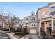 Townhomes feature tan siding, brick foundations, stairways to entry, and attached garages at 7108 Founders Club Ct, Charlotte, NC 28269
