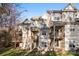 Rear view of townhomes shows private decks and patios overlooking a grassy lawn at 7108 Founders Club Ct, Charlotte, NC 28269