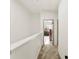 Hallway featuring gray carpet, white trim, and a view of additional rooms at 7108 Founders Club Ct, Charlotte, NC 28269