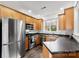 Well-lit kitchen features stainless steel appliances, wood cabinets, and ample counter space at 7108 Founders Club Ct, Charlotte, NC 28269