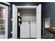 Laundry room features a modern washer and dryer set, with shelves for storage, enhancing convenience at 7108 Founders Club Ct, Charlotte, NC 28269