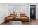 Stylish living room featuring an accent door, modern seating and natural light at 7108 Founders Club Ct, Charlotte, NC 28269