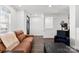 Open-concept living room with modern furniture, hardwood floors, and abundant natural light at 7108 Founders Club Ct, Charlotte, NC 28269