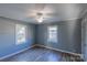 Well-lit bedroom featuring gray walls and laminate wood flooring at 853 Bradley St, Rock Hill, SC 29730