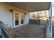 Covered back porch with wooden flooring and access to the backyard at 10310 Stokes Ferry Rd, Gold Hill, NC 28071