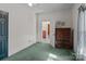 Bedroom with green carpet and wood dresser at 10310 Stokes Ferry Rd, Gold Hill, NC 28071