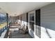 Long front porch with wooden swing and seating area at 10310 Stokes Ferry Rd, Gold Hill, NC 28071