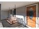 Front porch with wooden swing and glass front door at 10310 Stokes Ferry Rd, Gold Hill, NC 28071