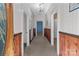 Long hallway with wood paneling and carpeted floors at 10310 Stokes Ferry Rd, Gold Hill, NC 28071