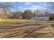 Ranch-style home with metal roof and detached garage at 10310 Stokes Ferry Rd, Gold Hill, NC 28071