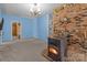 Cozy living room featuring a wood-burning stove and brick accent wall at 10310 Stokes Ferry Rd, Gold Hill, NC 28071