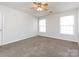 Bedroom with ceiling fan, carpet, and two windows at 11813 Fox Glen Rd, Charlotte, NC 28269