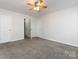 Bright bedroom with ceiling fan and access to bathroom at 11813 Fox Glen Rd, Charlotte, NC 28269