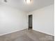 Spacious bedroom with carpet and access to hallway at 11813 Fox Glen Rd, Charlotte, NC 28269