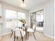 Bright dining area with glass table and four chairs, leading to a sunroom at 11813 Fox Glen Rd, Charlotte, NC 28269