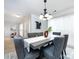 Bright dining room with gray chairs and a modern chandelier at 11813 Fox Glen Rd, Charlotte, NC 28269