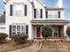 Two-story house with white siding, gray roof, and red front door at 11813 Fox Glen Rd, Charlotte, NC 28269