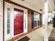 Brick front porch with red door and black shutters at 11813 Fox Glen Rd, Charlotte, NC 28269