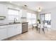 Kitchen with breakfast nook, stainless steel appliances, and white cabinets at 11813 Fox Glen Rd, Charlotte, NC 28269