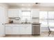 Well-lit kitchen with white cabinets, granite countertops and a dishwasher at 11813 Fox Glen Rd, Charlotte, NC 28269