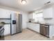 Bright kitchen with white cabinets, granite counters and stainless steel appliances at 11813 Fox Glen Rd, Charlotte, NC 28269