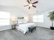 Main bedroom with king bed, ceiling fan, and large windows at 11813 Fox Glen Rd, Charlotte, NC 28269