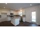 Bright kitchen featuring white cabinets, stainless steel appliances, granite countertops, and dark wood flooring at 2608 Clipper Nw Ct, Concord, NC 28027