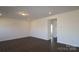 An open-concept living room featuring recessed lighting, base molding and dark wood flooring at 2608 Clipper Nw Ct, Concord, NC 28027