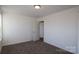 This bedroom features neutral walls and carpet with a light fixture at 2612 Clipper Nw Ct, Concord, NC 28027