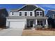 Two-story home featuring a covered entry, a two-car garage, and professional landscaping at 2612 Clipper Nw Ct, Concord, NC 28027