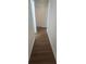 Clean hallway with dark brown luxury vinyl plank flooring and white walls at 2623 Trumpet Ct, Fort Mill, SC 29715