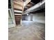 Unfinished basement with stairs and concrete floor at 325 Hunter St, Salisbury, NC 28144