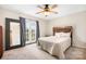 Bedroom with double doors leading to a balcony and ceiling fan at 3706 Selwyn Farms Ln # 17-3, Charlotte, NC 28209