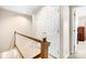 Upstairs hallway with wooden railing and storage at 3706 Selwyn Farms Ln # 17-3, Charlotte, NC 28209