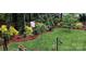 Landscaped backyard with mature trees and a curved border at 663 14Th Nw Ave, Hickory, NC 28601