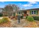 Brick ranch home with landscaped front yard, fountain, and inviting entryway at 663 14Th Nw Ave, Hickory, NC 28601