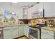 Kitchen with stainless steel appliances and light green shaker cabinets at 663 14Th Nw Ave, Hickory, NC 28601