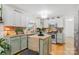 Eat-in kitchen with island, stainless steel appliances, and light green cabinets at 663 14Th Nw Ave, Hickory, NC 28601