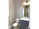 This bathroom has a toilet, a sink with a marble countertop, and a gray cabinet at 143 Dabbling Duck Cir, Mooresville, NC 28117