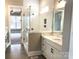 This bathroom has a walk-in glass shower and marble countertops with white cabinets and black hardware at 143 Dabbling Duck Cir, Mooresville, NC 28117