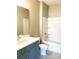 This bathroom features an integrated tub-shower combo, a toilet, and a blue sink cabinet at 143 Dabbling Duck Cir, Mooresville, NC 28117