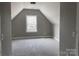 Attic bedroom featuring neutral walls, carpeting, and a dormer window overlooking the backyard at 143 Dabbling Duck Cir, Mooresville, NC 28117