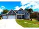 Charming two-story home with a well-manicured lawn and a two-car garage at 143 Dabbling Duck Cir, Mooresville, NC 28117
