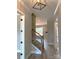 Inviting hallway with wooden staircase and hardwood floors offering a glimpse into the spacious living area at 143 Dabbling Duck Cir, Mooresville, NC 28117
