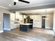 Spacious open kitchen with a large island, white cabinets, modern appliances, and hardwood floors at 143 Dabbling Duck Cir, Mooresville, NC 28117