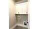 This laundry room features modern white cabinets and streamlined fittings at 143 Dabbling Duck Cir, Mooresville, NC 28117