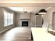Open-concept living room with a fireplace, built-in cabinets, and views from the kitchen island at 143 Dabbling Duck Cir, Mooresville, NC 28117